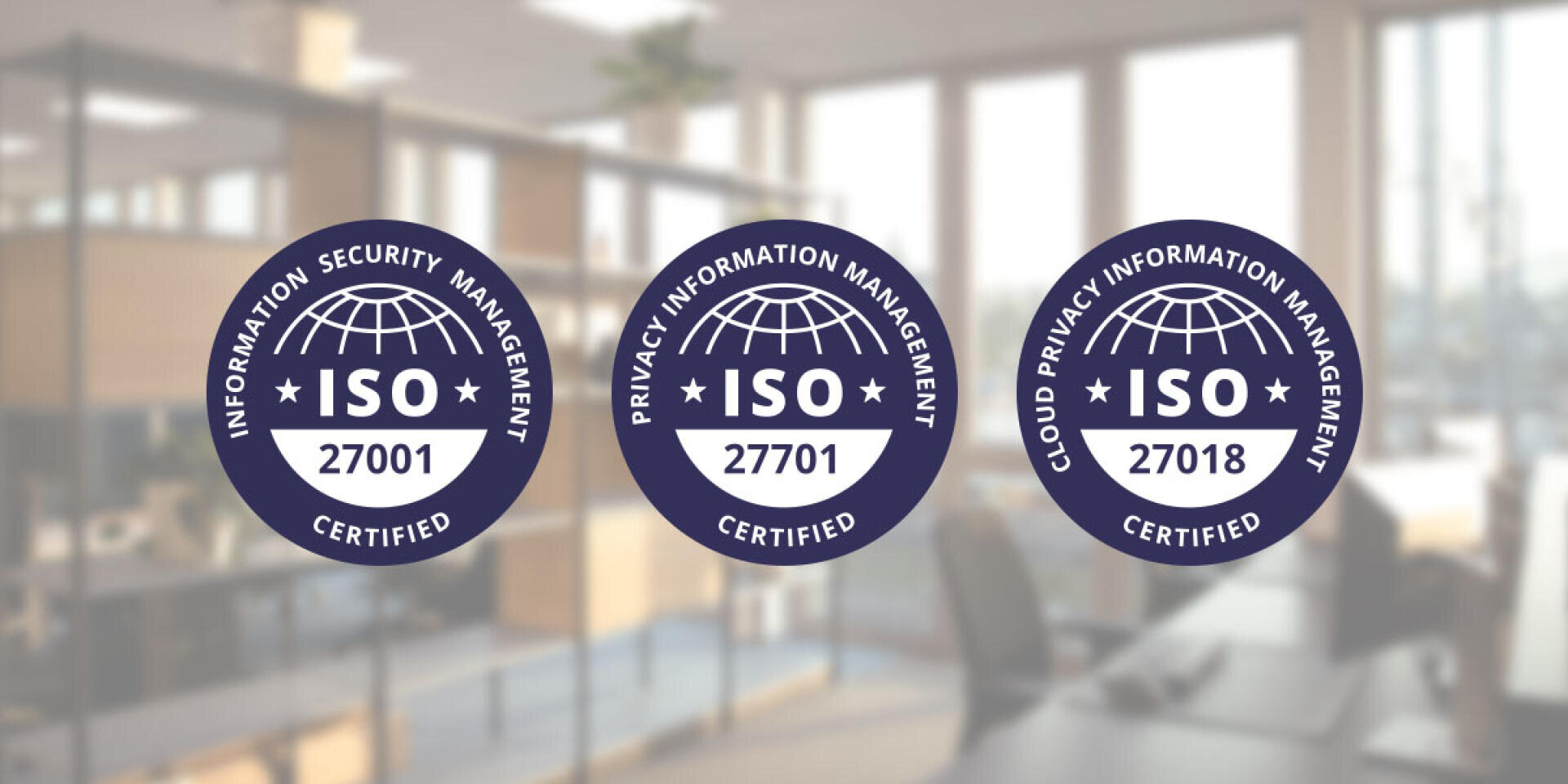 Drei ISO-Zertifizierungssiegel – 27001, 27701 und 27018 – sind vor einem unscharfen Bürohintergrund in einer Reihe angeordnet und heben die Standards für Informationssicherheit, Datenschutz und Cloud-Datenschutzmanagement hervor.