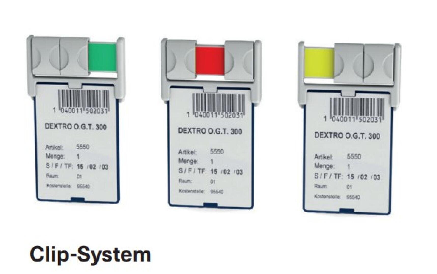 On voit trois cartes étiquetées, maintenues par des pinces de couleur verte, rouge et jaune. Sur chaque carte figurent un code-barres, la mention « DEXTRO O.G.T. 300 » ainsi que des informations sur le produit. Sous les cartes, on peut lire « Clip-System ».